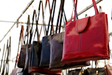 bags+rows+in+retail+shop+handbags+leather+red+in+foreground