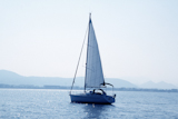 sailboat+sailing+in+blue+mediterranean+sea+mountain+horizon+Denia+Spain