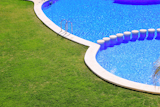 blue+tiles+swimming+pool+with+green+grass+garden+around