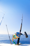 fishing+boat+trolling+with+outrigger+gear+and+golden+reel+rod