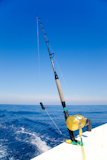 fishing+boat+trolling+in+ocean+with+golden+reel+rod