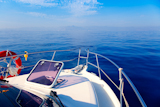 Blue+sea+boat+sailing+with+open+bow+porthole+in+summer+vacations
