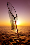 dip+net+in+boat+fishing+on+sunrise+water+horizon