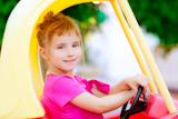 blond+children+girl+driving+toy+car+yellow