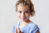 almost+happy+children+kid+girl+with+syringe+of+antibiotic+medicine
