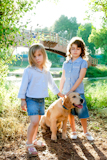 kid+girls+with+Golden+retriever+puppy+outdoor+park+river