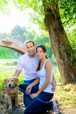 couple+happy+posing+with+golden+retirever+dog+in+outdoor+park