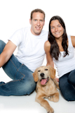couple+in+love+with+puppy+dog+golden+retriever+isolated+on+white