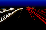 car+light+trails+in+red+and+white+on+night+road+curve