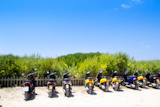 Formentera+scooter+bikes+parking+near+the+beach+in+Spain