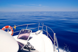 Boat+bow+open+porthole+sailing+in+blue+calm+sea+during+summer+vacations