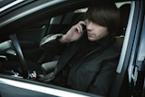 Elegant+man+talking+over+cellphone+in+his+car