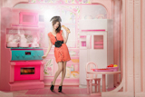 Young+woman+like+a+doll+cokking+in+pink+kitchen