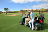 Couple,on,golf,course,with,cart