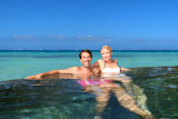 Cheerful couple relaxing in resort pool