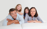 Family of 4 people laying down couch