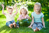 Group of happy children playing outdoors in spring park