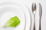 close-up,shot,of,place,setting,with,lettuce,leaf