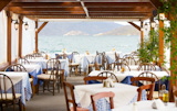 view of empty outdoor restaurant on the seashore, greece 
