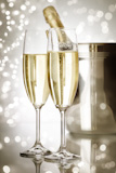 champagne flutes and ice bucket with lights and reflections