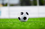 new and clean soccer ball on field, selective focus