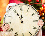Child,holding,vintage,clock,against,Christmas,lights,background