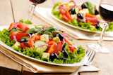 Vegetable salad and glass of red wine