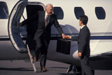 Man+Greeting+Business+Traveler+Stepping+Off+Plane