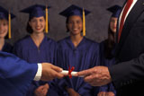 Man+Handing+Diploma+To+Graduate