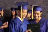 Graduates+Looking+At+Diploma+And+Smiling