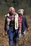 Elderly+Couple+Hiking+Through+Brush