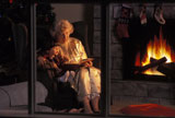 Grandma+Reading+Story+To+Grandson+Next+To+Fireplace