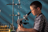 Boy+Looking+Into+Microscope+In+Chemistry+Class