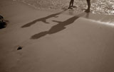 Shadows+Of+Father+And+Son+Playing+On+Beach
