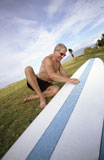 Middle-Aged+Male+Surfer+Waxing+His+Surfboard