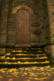 Autumn+Leaves+Lining+The+Steps+To+A+Wooden+Cathedral+Door