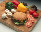 a+burger+on+a+bun+with+salad%2Fvegetable+items