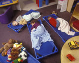 Children+Napping+On+Floor+Of+Preschool+Classroom