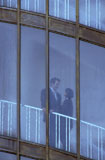 Couple+Standing+Behind+Windows