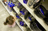 Little+Girl+Looking+at+Pots+and+Pans+in+a+Store