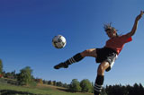 Woman+Kicking+Soccer+Ball