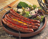 Grilled+frankfurters+served+with+an+olives+and+feta+cheese+salad