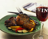 Pork+chops+served+with+vegetables+and+a+glass+of+red+wine