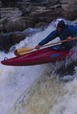Close-up+of+a+man+canoeing+in+white+water+rapids