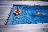High+angle+view+of+a+father+with+his+son+in+a+swimming+pool