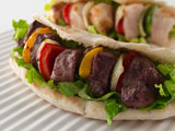 Close-up+of+grilled+meat+and+vegetables+in+pita+bread+sandwiches