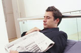 Side+profile+of+a+businessman+sleeping+with+a+newspaper+on+his+chest