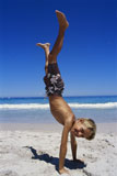 Boy+doing+a+handstand+on+the+beach