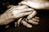 Close-up+of+a+senior+woman%27s+hands+holding+her+granddaughter%27s+hands
