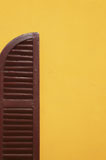 Brown+wooden+shutter+in+yellow+wall